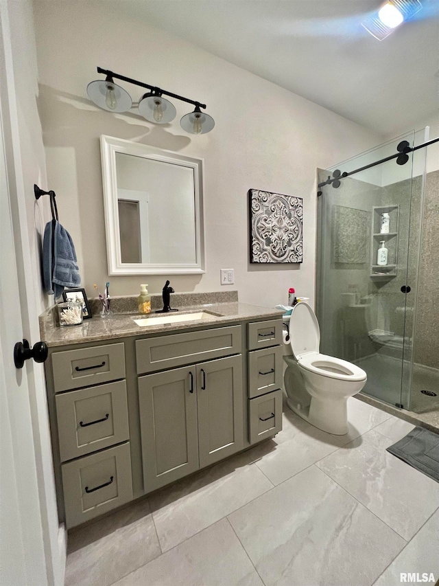 bathroom with vanity, toilet, and a shower with shower door