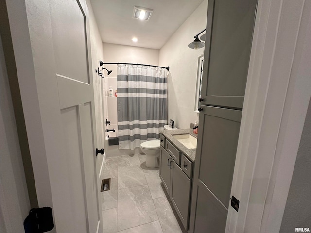 bathroom with curtained shower, vanity, and toilet