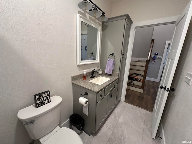 bathroom with vanity, hardwood / wood-style floors, and toilet