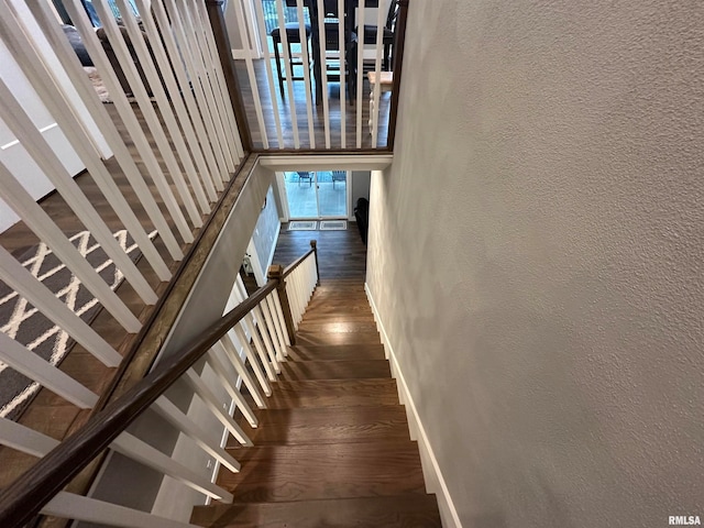 staircase with hardwood / wood-style flooring