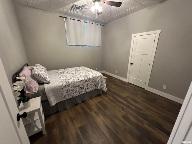 bedroom with ceiling fan and dark hardwood / wood-style floors