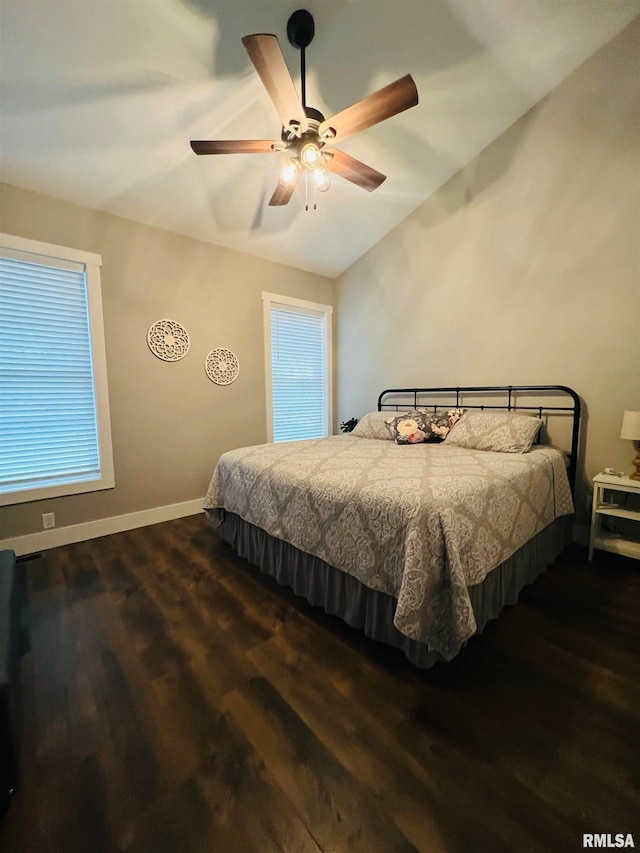 bedroom with ceiling fan, vaulted ceiling, and dark hardwood / wood-style flooring