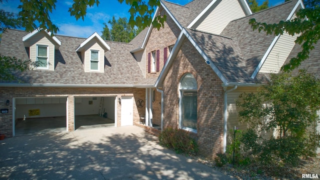 1803 N Dawn Dr, Marion, IL 62959 - view of front of home featuring brick siding, driveway, a garage, and roof with shingles