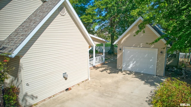 view of side of home featuring an outbuilding and a garage