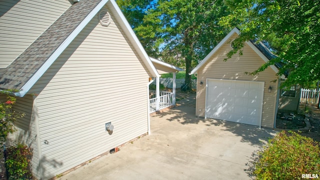 1803 N Dawn Dr, Marion, IL 62959 - view of property exterior featuring an outbuilding, a detached garage, fence, and roof with shingles