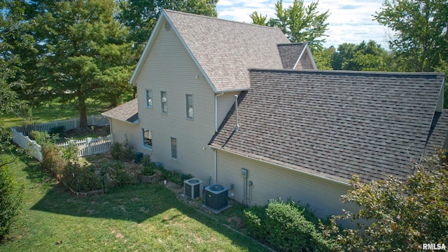 1803 N Dawn Dr, Marion, IL 62959 - view of home's exterior with a lawn, fence, cooling unit, and roof with shingles