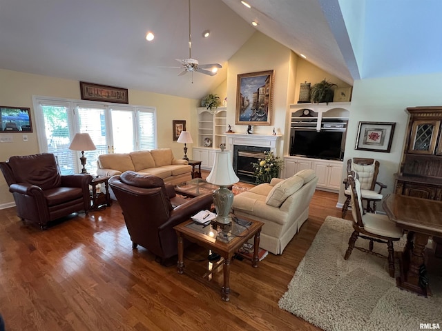 living room with ceiling fan, dark wood-type flooring, and high vaulted ceiling