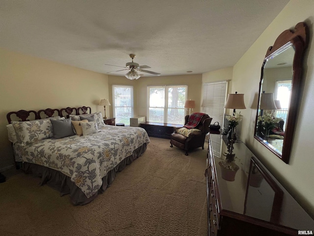 carpeted bedroom with a textured ceiling and ceiling fan