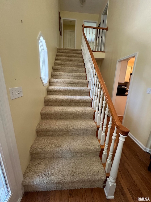 stairs with hardwood / wood-style flooring