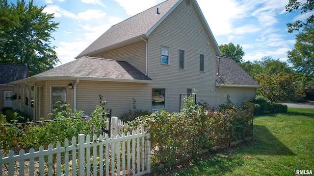 1803 N Dawn Dr, Marion, IL 62959 - view of property exterior featuring a shingled roof, fence, and a yard