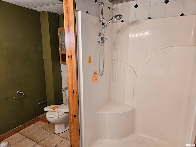 bathroom featuring a shower, toilet, and tile patterned floors