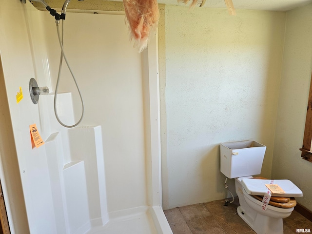 bathroom with walk in shower and toilet