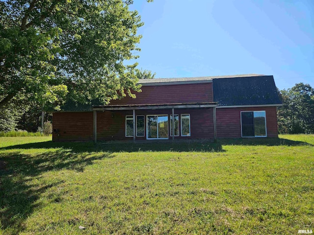 rear view of house with a yard