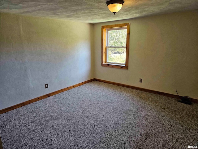 unfurnished room with a textured ceiling and carpet