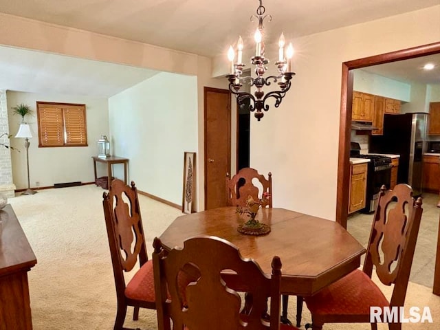 carpeted dining room featuring a chandelier