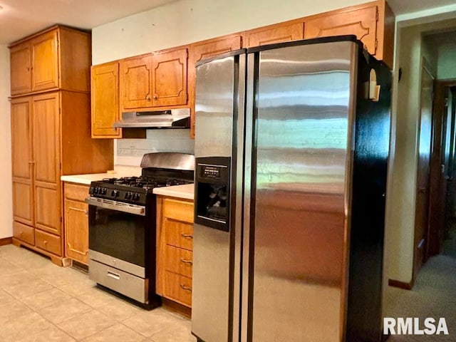 kitchen with stainless steel appliances and light tile patterned floors