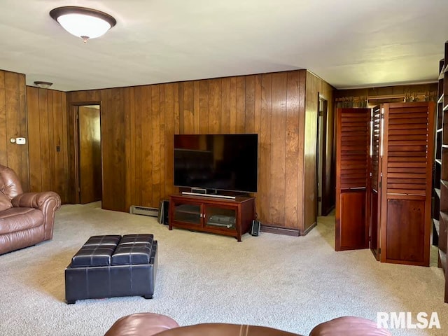 living room featuring light carpet, wood walls, and baseboard heating