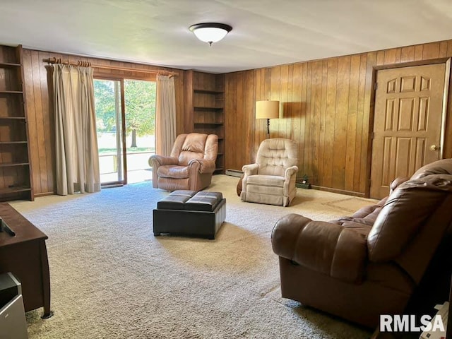 living area with carpet floors, a baseboard radiator, wooden walls, and built in features