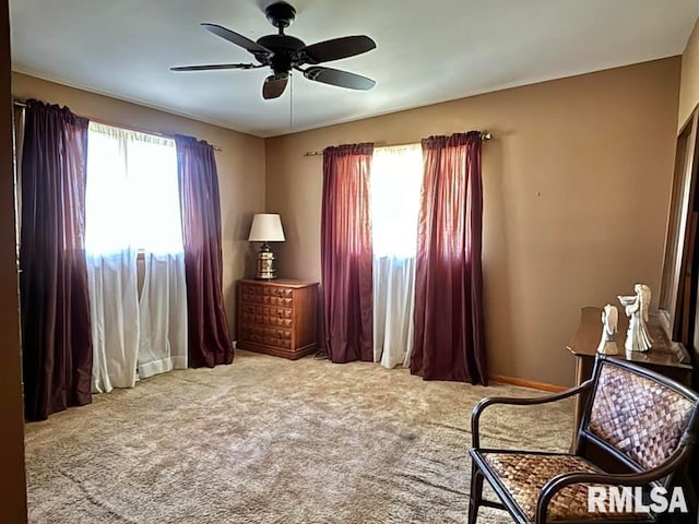 sitting room with plenty of natural light, ceiling fan, and light colored carpet