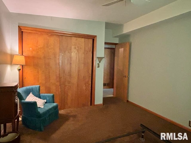 sitting room featuring ceiling fan, carpet floors, and baseboards