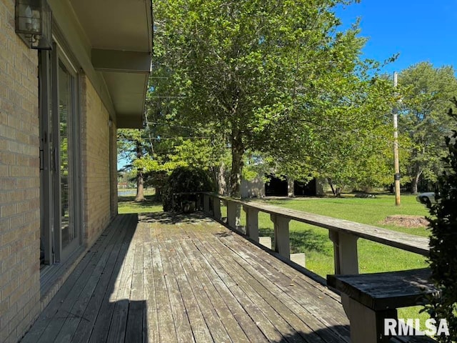 wooden terrace featuring a yard