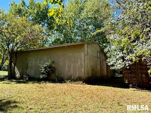 view of side of home with a yard