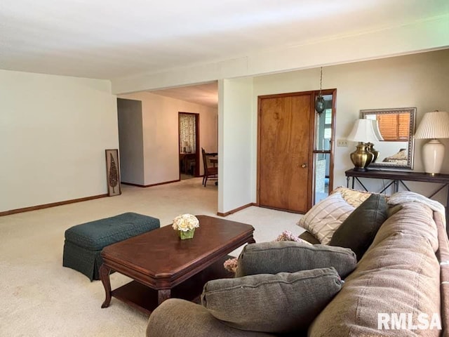 living area featuring baseboards and light colored carpet