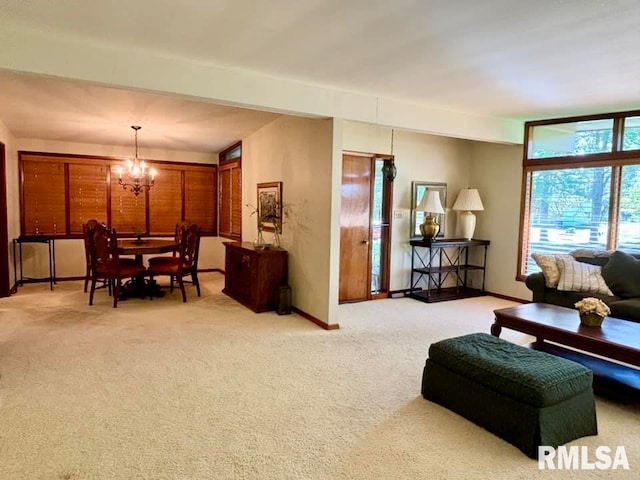 living room with light carpet, baseboards, and a notable chandelier