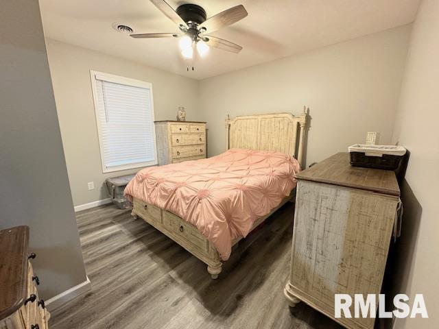 bedroom with ceiling fan and dark hardwood / wood-style flooring