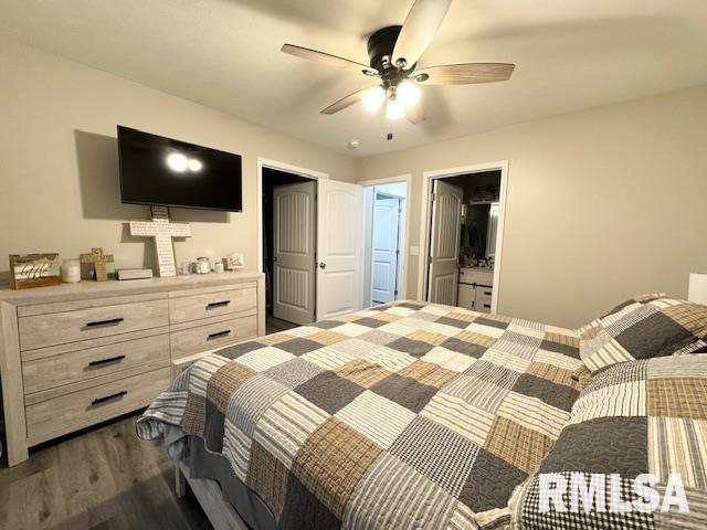 bedroom featuring ceiling fan, ensuite bath, and dark hardwood / wood-style floors