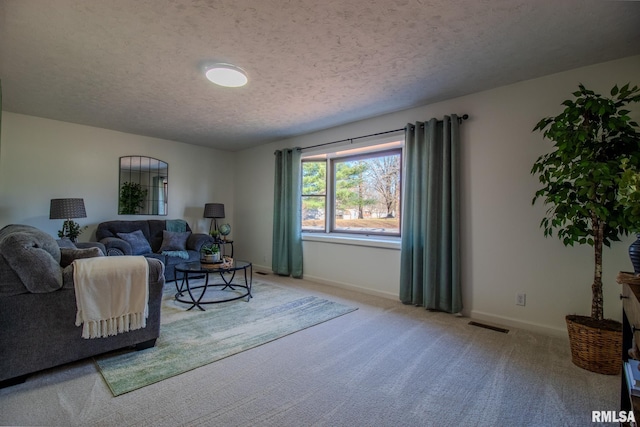 carpeted living room featuring a textured ceiling