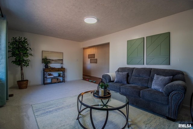 carpeted living room with a textured ceiling