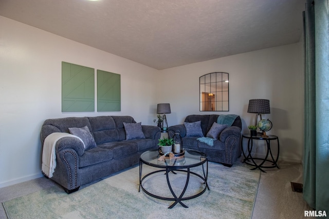 carpeted living room featuring a textured ceiling