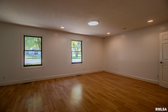 unfurnished room with hardwood / wood-style floors