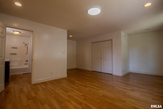 unfurnished bedroom featuring a closet and light hardwood / wood-style flooring