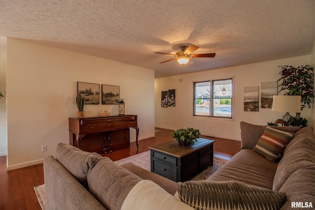 living room featuring a textured ceiling, dark hardwood / wood-style floors, and ceiling fan