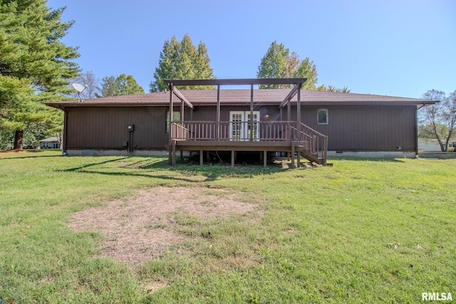 rear view of house with a wooden deck and a yard