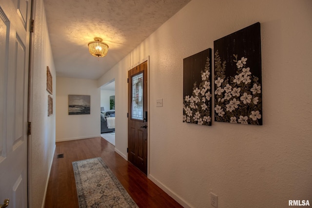 interior space featuring dark hardwood / wood-style flooring and a textured ceiling