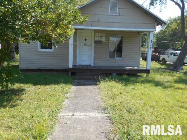 bungalow with a front lawn and covered porch