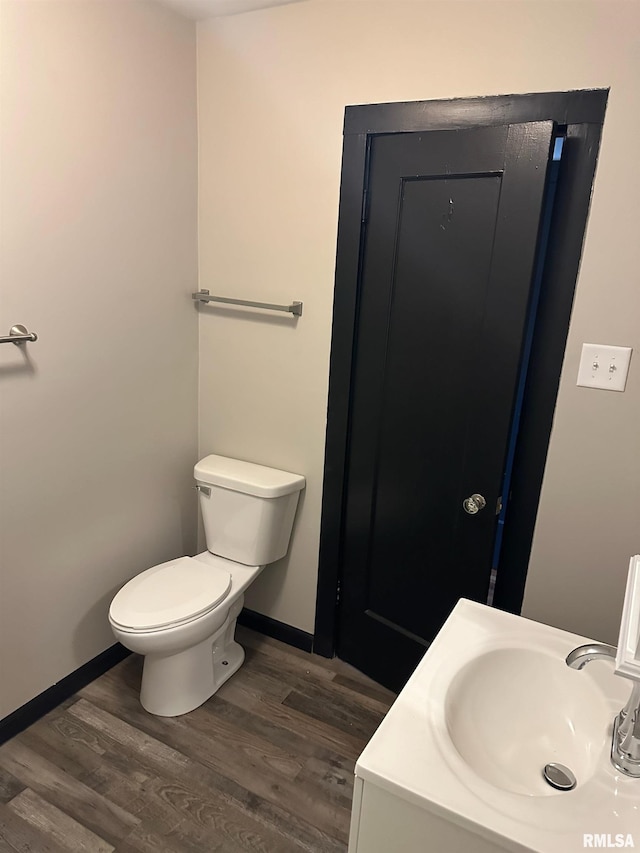 bathroom featuring hardwood / wood-style flooring, sink, and toilet