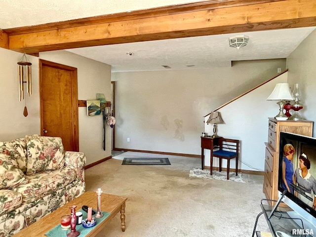 carpeted living room featuring beamed ceiling