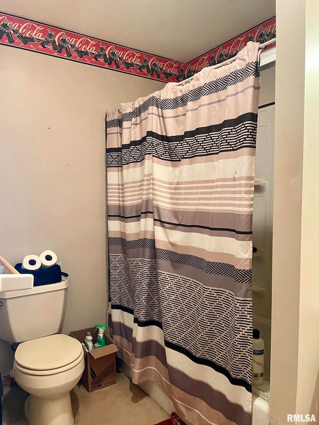 bathroom with toilet and curtained shower