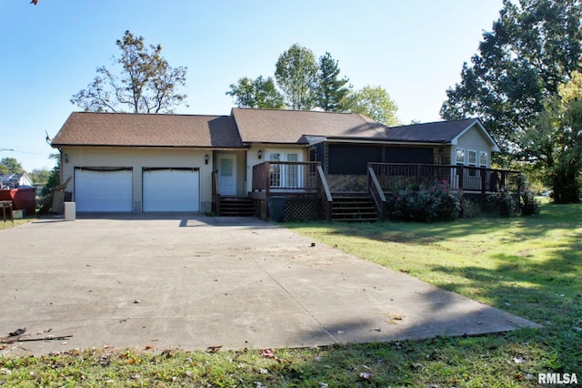 ranch-style house featuring a front yard and a garage