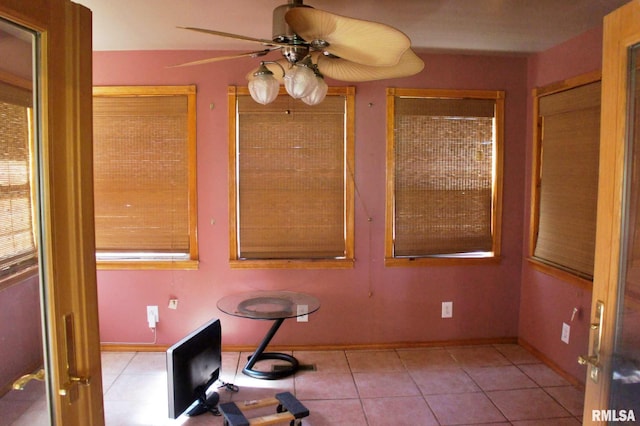 unfurnished dining area with ceiling fan and light tile patterned flooring