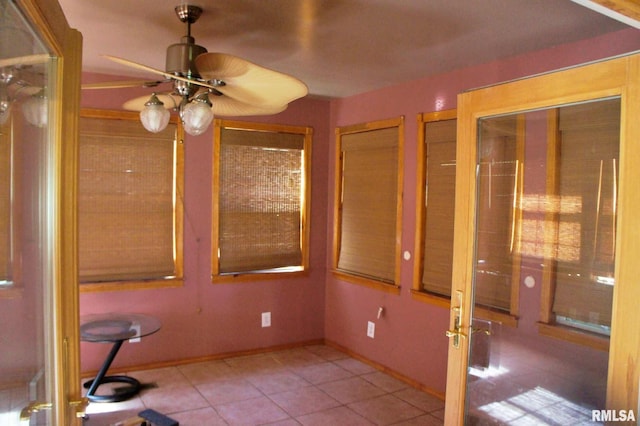 interior space with ceiling fan