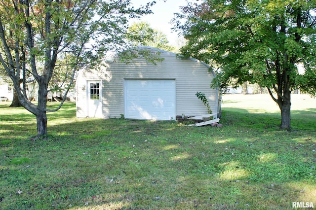 garage featuring a yard