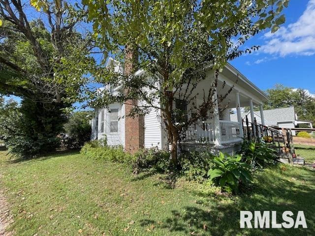 view of side of property with a lawn