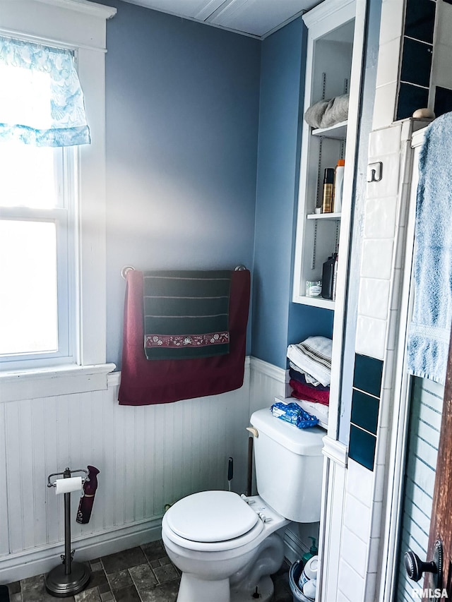 bathroom with toilet and a shower