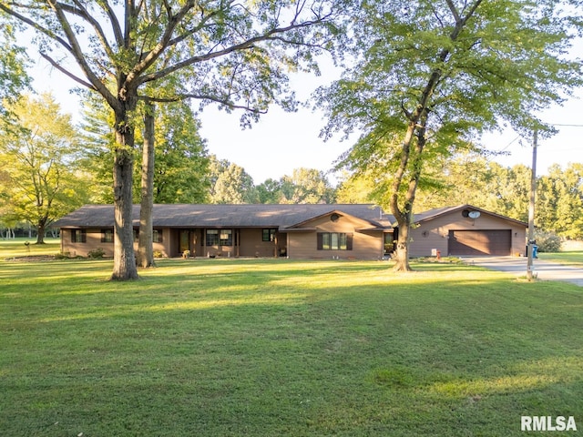 ranch-style house featuring a garage and a front yard