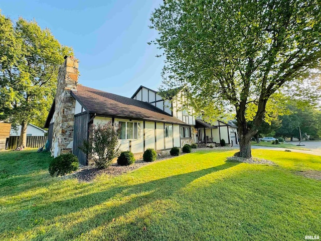 view of side of home featuring a lawn